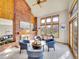 Bright living room with a cozy fireplace, vaulted ceilings, and large windows with natural light at 6505 S Garfield Ct, Centennial, CO 80121