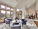 Bright living room with vaulted ceilings, large windows, and a dining area with a modern chandelier at 6505 S Garfield Ct, Centennial, CO 80121