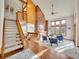 Bright living room with a striking brick fireplace, vaulted ceilings, and a staircase at 6505 S Garfield Ct, Centennial, CO 80121