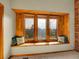 Inviting window seat in wood trim surrounded by green landscape offers a relaxing space at 6505 S Garfield Ct, Centennial, CO 80121