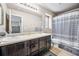 Bathroom with double vanity, shower/tub combo, and updated fixtures at 11590 River Oaks Ln, Commerce City, CO 80640