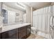 Clean bathroom with dark vanity, shower/tub combo, and updated fixtures at 11590 River Oaks Ln, Commerce City, CO 80640