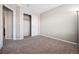 Well-lit bedroom featuring a large closet and carpet flooring at 11590 River Oaks Ln, Commerce City, CO 80640