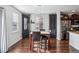 Dining area with dark brown cabinets and a modern chandelier at 11590 River Oaks Ln, Commerce City, CO 80640