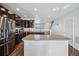 Spacious kitchen with dark cabinetry, stainless steel appliances, and an island at 11590 River Oaks Ln, Commerce City, CO 80640
