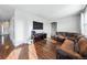 Living room with hardwood floors, sectional sofa, and entryway at 11590 River Oaks Ln, Commerce City, CO 80640
