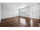 Living room with hardwood floors, neutral walls, and an entryway at 11590 River Oaks Ln, Commerce City, CO 80640