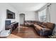 Living room featuring hardwood floors, a large sectional sofa, and a TV at 11590 River Oaks Ln, Commerce City, CO 80640