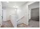 Upstairs hallway with carpeted flooring and access to bedrooms at 11590 River Oaks Ln, Commerce City, CO 80640
