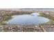 Expansive aerial view of a serene lake surrounded by lush greenery, with city skyline in the distance at 2944 Hooker St, Denver, CO 80211
