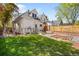 Spacious backyard with a lush lawn, wooden fence, and patio area at 2944 Hooker St, Denver, CO 80211
