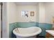 Bathroom featuring a standalone tub and blue tile accents at 2944 Hooker St, Denver, CO 80211