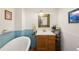 Bright bathroom boasting a classic tub and wooden vanity at 2944 Hooker St, Denver, CO 80211