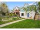 Charming home with a well-maintained lawn and a walkway leading to the front door at 2944 Hooker St, Denver, CO 80211