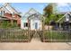 Charming home featuring a quaint front yard with a wooden fence and an ornate wooden archway at 2944 Hooker St, Denver, CO 80211