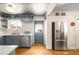 Kitchen featuring a stainless steel fridge, and a door leading to the outside at 2944 Hooker St, Denver, CO 80211