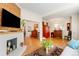 Spacious open living area featuring hardwood floors and a cozy fireplace at 2944 Hooker St, Denver, CO 80211