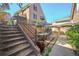 Cozy backyard with multiple seating areas, including a dining set under a striped umbrella at 999 N Emerson St # 10, Denver, CO 80218