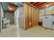 Unfinished basement area with exposed beams, laundry area, and storage, offering ample space for customization at 999 N Emerson St # 10, Denver, CO 80218