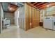 Unfinished basement area with laundry setup, utility sink, and exposed ceiling at 999 N Emerson St # 10, Denver, CO 80218