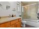 Clean bathroom with a glass-enclosed shower, wooden cabinets, and a bright window view at 999 N Emerson St # 10, Denver, CO 80218