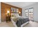 Comfortable bedroom featuring a brick accent wall, stylish decor, and a balcony with a view at 999 N Emerson St # 10, Denver, CO 80218