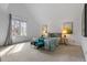 Bright bedroom featuring vaulted ceiling, a large window, and comfortable seating area at 999 N Emerson St # 10, Denver, CO 80218