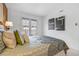 Bright bedroom with balcony access, clean white walls, and modern artwork at 999 N Emerson St # 10, Denver, CO 80218