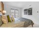 Bedroom with light-colored walls and carpet showcases a bed and balcony with double doors and modern, abstract paintings at 999 N Emerson St # 10, Denver, CO 80218