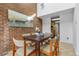 Dining room with high ceilings, brick accent wall and comfortable seating at 999 N Emerson St # 10, Denver, CO 80218