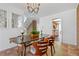 Open dining area with a wooden table, stylish chairs, chandelier, and a view into the kitchen at 999 N Emerson St # 10, Denver, CO 80218