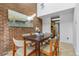 Bright dining area showcasing brick accents, a window, and modern dining furniture at 999 N Emerson St # 10, Denver, CO 80218