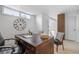 Office featuring a classic wood desk and decorative wall clock, with natural light streaming through the windows at 999 N Emerson St # 10, Denver, CO 80218