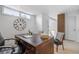 Office area featuring a large wooden desk and unique clock, with a cozy chair at 999 N Emerson St # 10, Denver, CO 80218