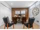 Office with exposed brick wall, complemented by a classic wood desk, two chairs, and a decorative wall clock at 999 N Emerson St # 10, Denver, CO 80218