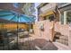 Private patio featuring brick flooring, a decorative fountain, and an umbrella-covered dining set at 999 N Emerson St # 10, Denver, CO 80218