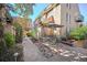 Charming patio with lush greenery, dining area, and shade from mature trees at 999 N Emerson St # 10, Denver, CO 80218