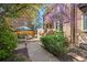 Beautiful patio area with lush landscaping, dining set, and shade for relaxing outdoors at 999 N Emerson St # 10, Denver, CO 80218