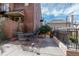 Relaxing patio area with an iron table set, brick and concrete flooring, and views of the well-manicured yard at 999 N Emerson St # 10, Denver, CO 80218