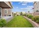 Expansive backyard with lush green lawn and retaining wall providing privacy and a picturesque outdoor space at 2008 Makley Loop, Castle Rock, CO 80104