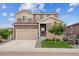 Beautiful two-story home with a two car garage, well-maintained lawn, and stone accents at 2008 Makley Loop, Castle Rock, CO 80104