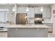 Modern kitchen with stainless steel appliances, island with granite counters, and ample cabinet space at 2008 Makley Loop, Castle Rock, CO 80104