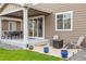 Covered patio with outdoor dining set, lounge chairs, and fire pit, perfect for relaxing and entertaining at 2008 Makley Loop, Castle Rock, CO 80104