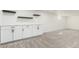 Basement featuring cabinets with white countertops and floating shelves on soft carpet at 6699 S Pennsylvania St, Centennial, CO 80121