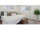 Comfortable bedroom with a well-made bed, two windows, and an area rug at 6699 S Pennsylvania St, Centennial, CO 80121