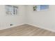 Clean and bright bedroom with wood floors, two windows, and neutral paint at 6699 S Pennsylvania St, Centennial, CO 80121