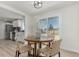 Bright dining area featuring a round table with four stylish chairs, view of the backyard and opening to the kitchen at 6699 S Pennsylvania St, Centennial, CO 80121