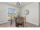 Bright dining area featuring a round table with four stylish chairs and sliding glass doors to the backyard at 6699 S Pennsylvania St, Centennial, CO 80121