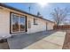 Brick home featuring a large sliding glass door that opens onto a concrete patio at 6699 S Pennsylvania St, Centennial, CO 80121