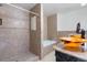 Bathroom featuring a tiled shower, soaking tub, and glass vessel sinks at 5555 Perth Ct, Denver, CO 80249